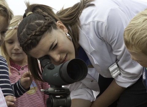 Children being educated about seabirds via a telescope at Scottish Seabird Centre, North Berwick, Scotland © Peter Cairns/2020VISION
