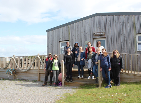 a group of people outside South Walney Nature Reserve visitor centre